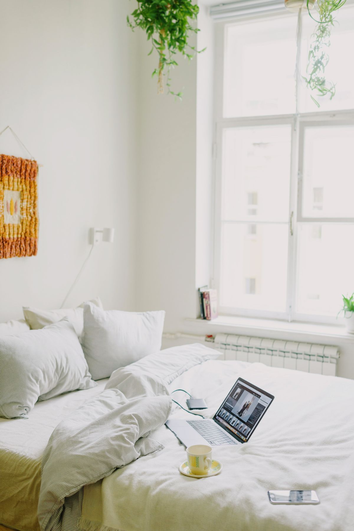 A tidy, freshly made cozy bedroom with natural light