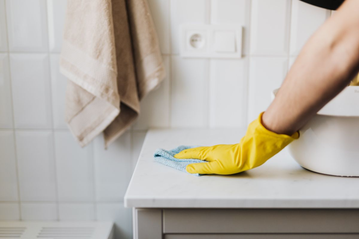 A team member wiping down a surface with a microfiber cloth